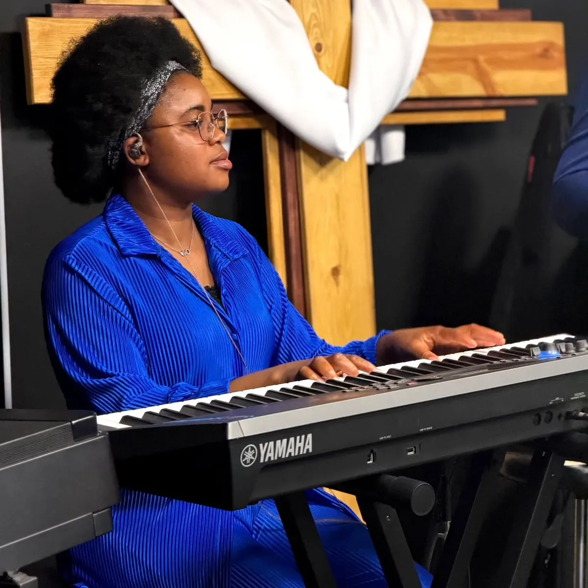 A musician serving during worship at Victory House